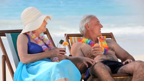 elderly couple drinking cocktails