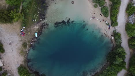 Cetina-River-Spring-or-Izvor-Cetine-also-Eye-Of-The-Earth-with-People-swimming-and-having-picnic,-Croatia