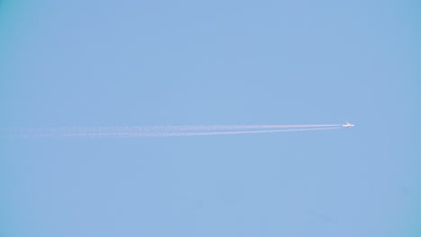 airplane in the sky with contrails