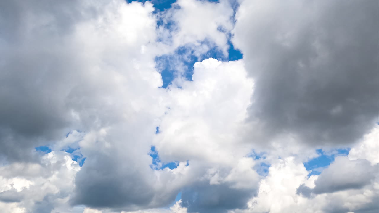 Moving forward among the amazing cumulus clouds. White clouds in the bright sunlight on summer day. Timelapse.