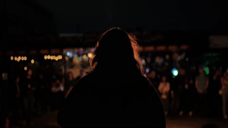 Woman-looking-at-fire-show-back-of-woman