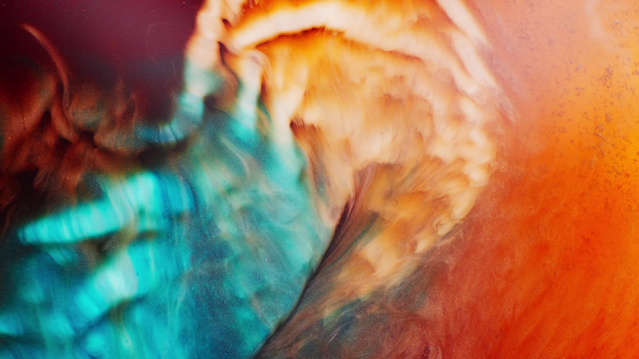 Closeup view of dramatic collision of colors forming shimmering galaxy