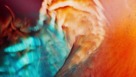 closeup view of dramatic collision of colors forming shimmering galaxy