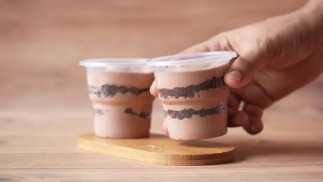 chocolate pudding cups on wooden tray