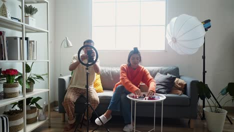 young couple filming a vlog at home