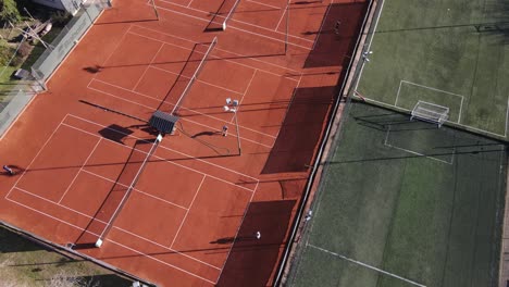 Players-enjoying-the-game-of-tennis-during-training-session-at-sports-complex