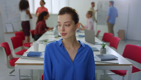 Portrait-pretty-woman-looking-camera-modern-office.-Lady-posing-in-meeting-room.