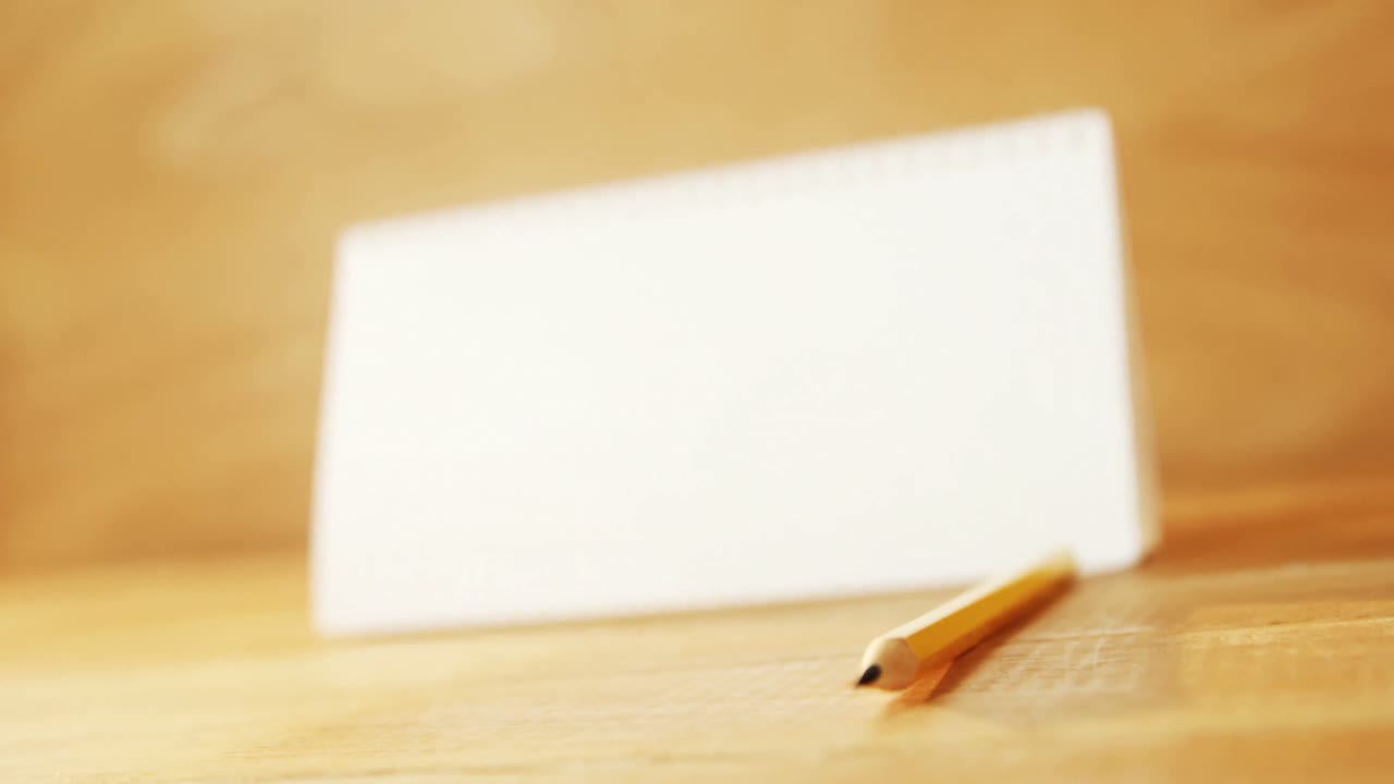 Close-up of blank spiral calendar with pencil
