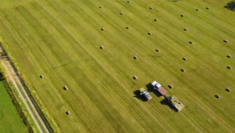 Vista-Aérea-De-La-Gente-Cosecha-Pacas-Cuadradas-En-Un-Campo