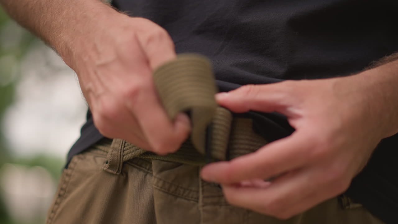 Individual Readying Outdoor Hiking Equipment, Person Organizes Safety Gear Before Adventure, Man Systematically Sorts Hiking Equipment And Safety Gear In Preparation For Outdoor Expedition