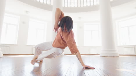 focused young man in casual wear performing a contemporary dance in the studio 1