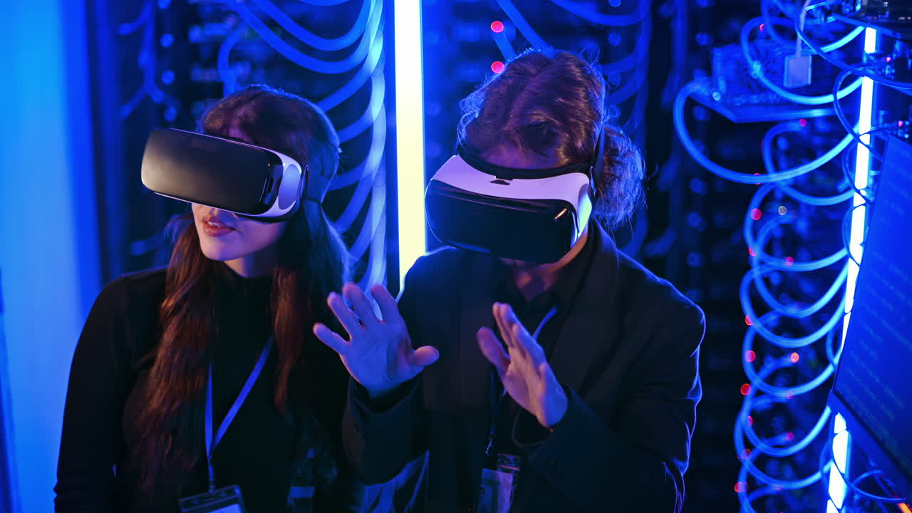 A man and a woman using Virtual Reality headsets in a server room