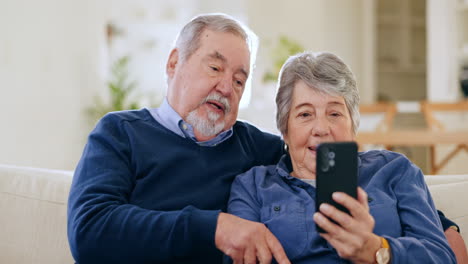 Phone,-funny-and-senior-couple-on-sofa-in-home