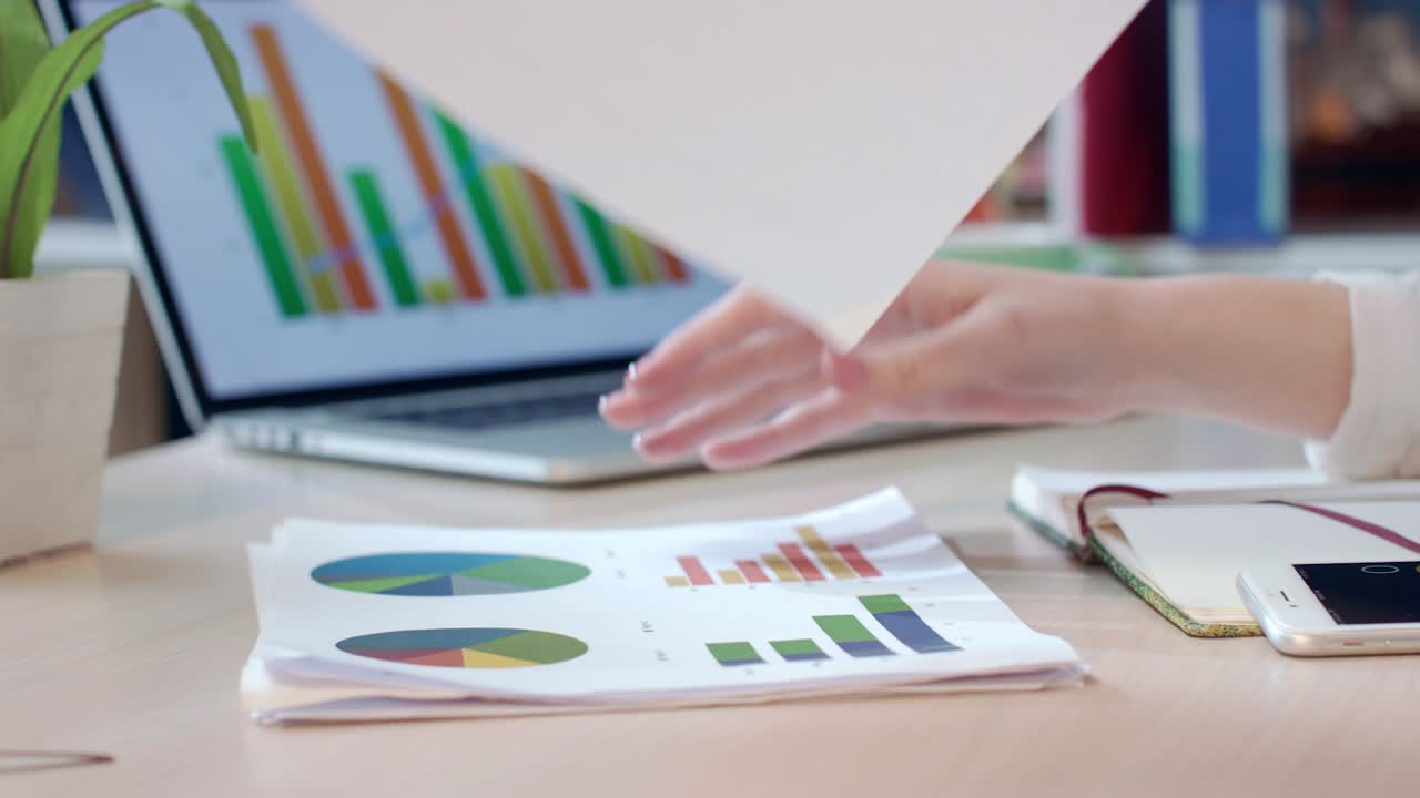 Forretningskvinde analyserer finansielle diagrammer på kontoret. Analyse af forretningspapirer.