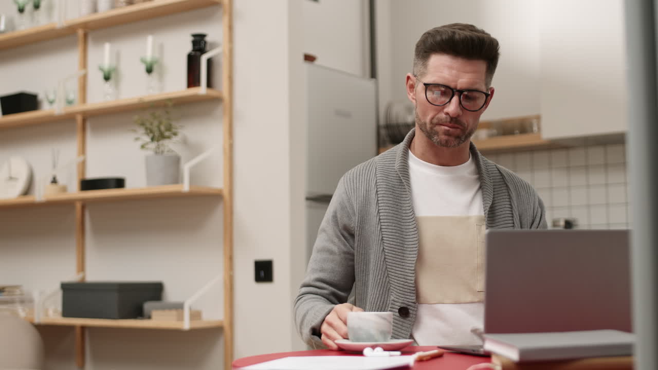 Man Drinking Tea and Working from Home