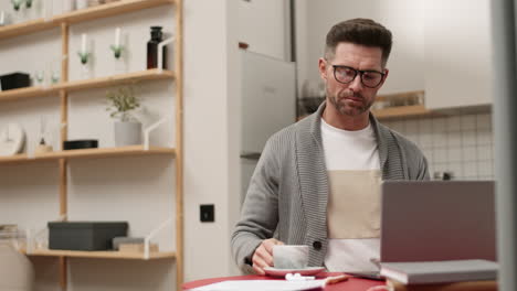 man drinking tea and working from home