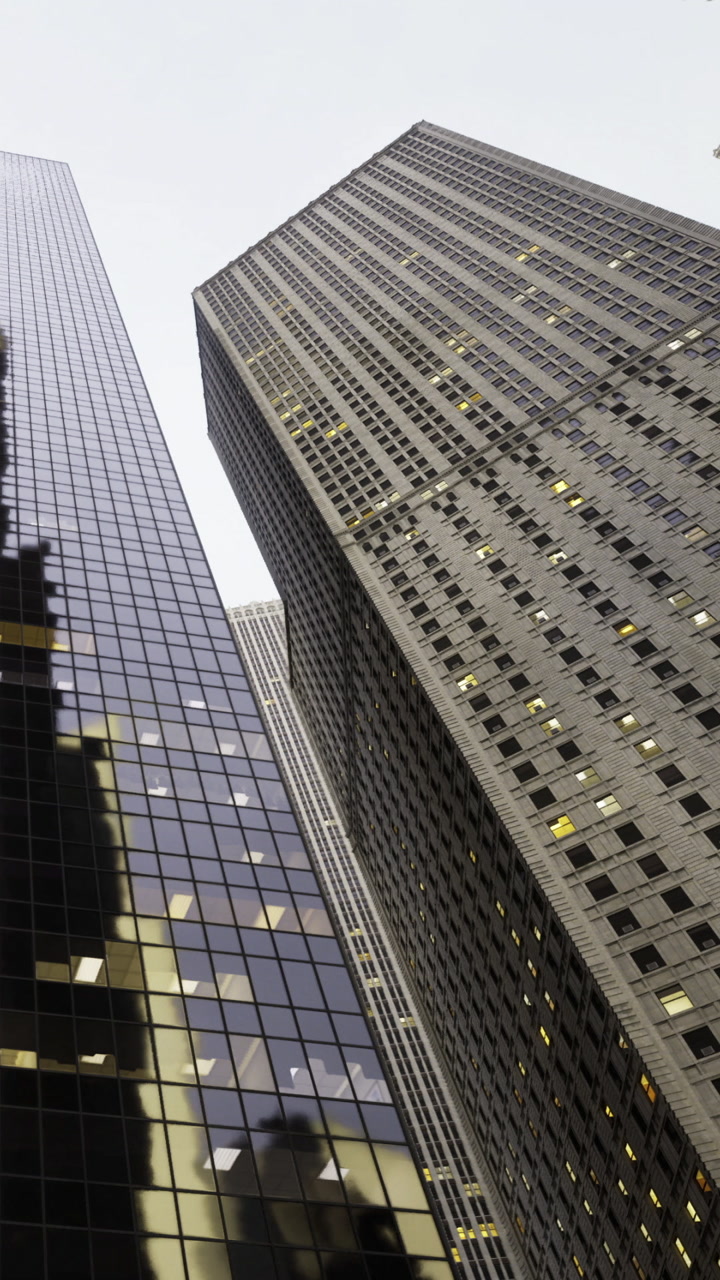 Tall buildings reach towards the sky in an urban environment during daylight