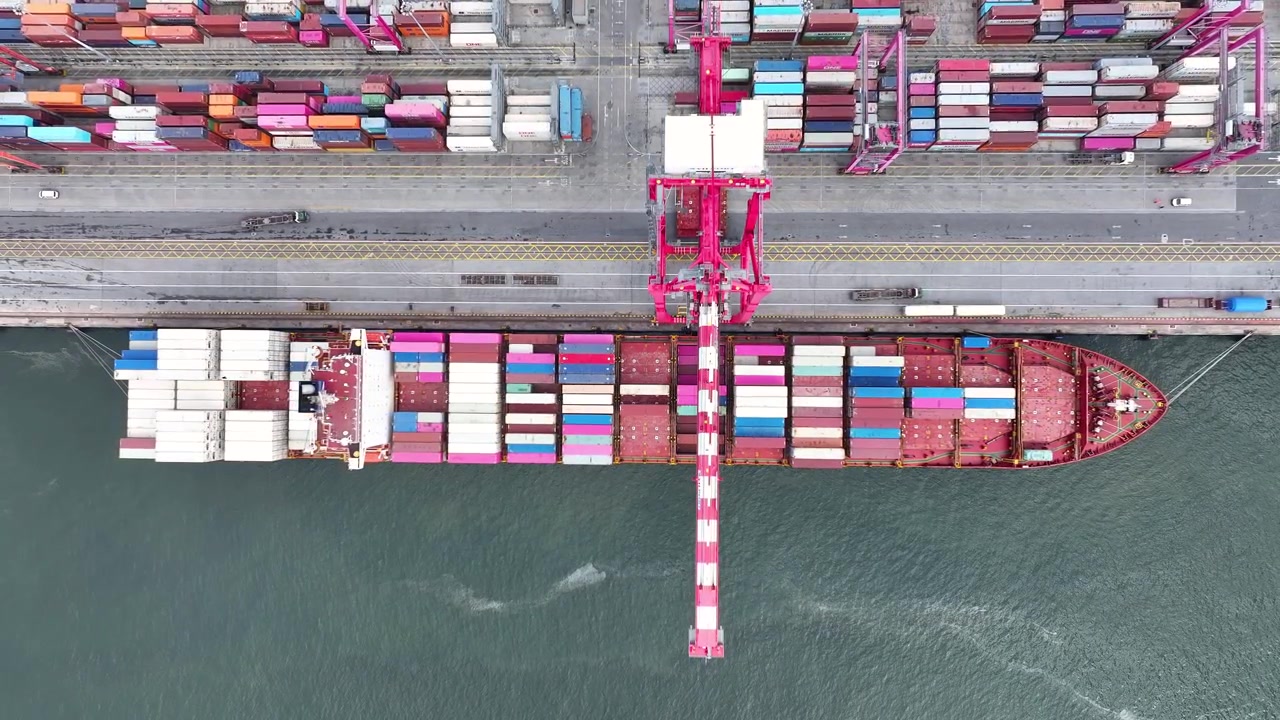 A massive container ship arrives at a bustling cargo port, ready to unload shipping containers filled with vital goods. This busy terminal showcases the heartbeat of international trade and logistics.
