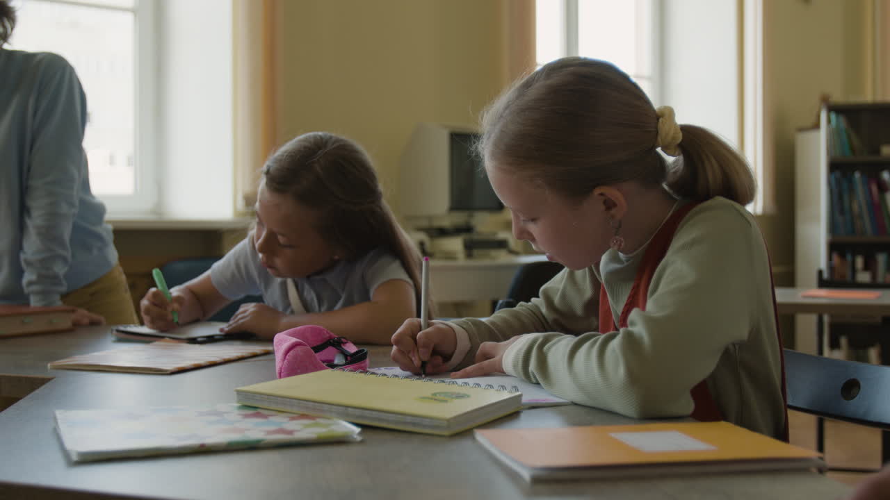 Children studying and drawing in a classroom