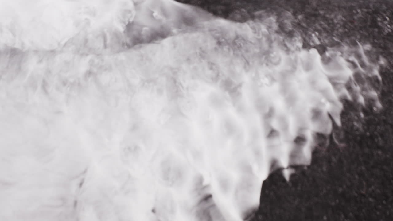 Blending of white ink with black ink forming shimmering galaxy. Closeup shot