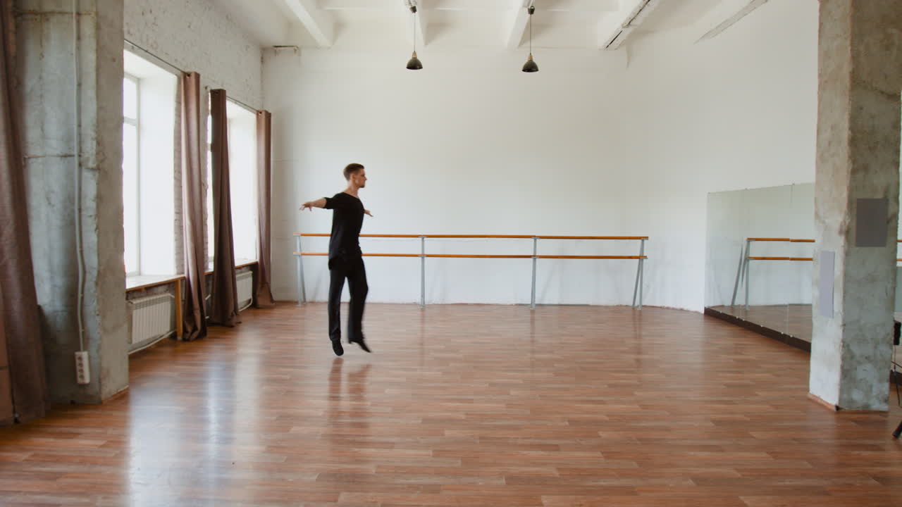 Male Dancer Performing Dynamic Movements and Jumps in a Bright Studio