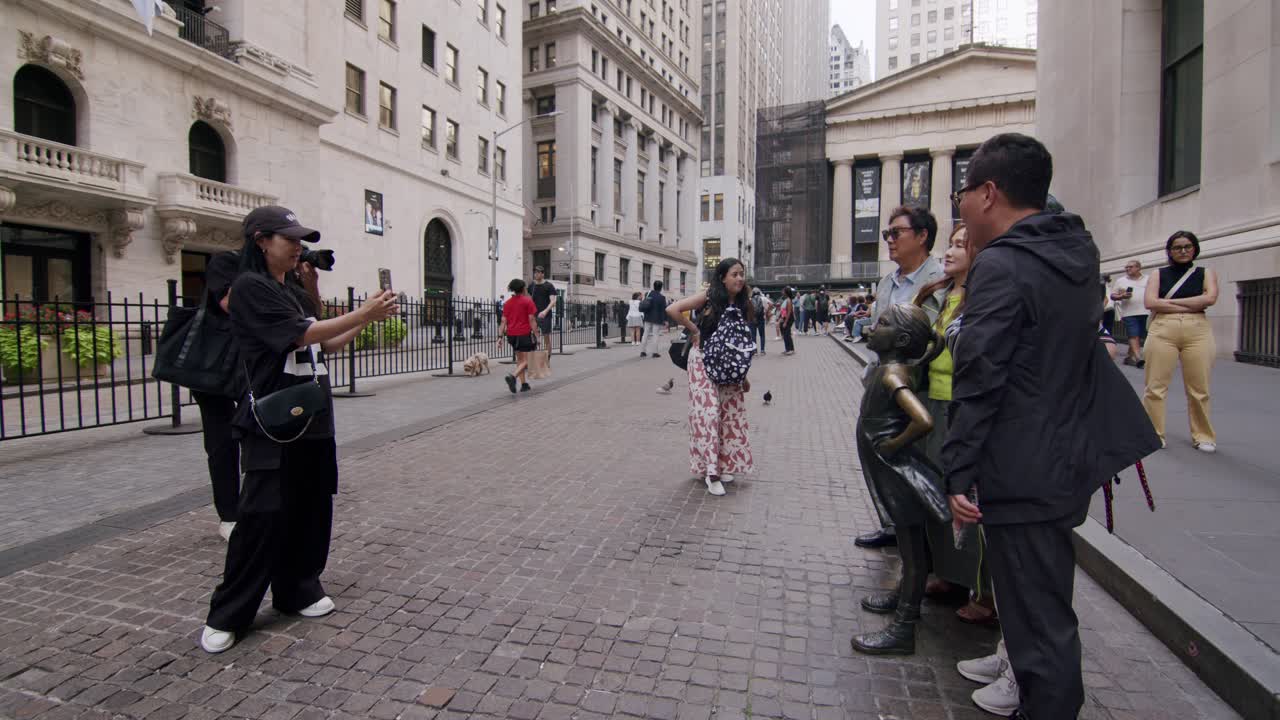 Tourists gather in front of New York’s iconic Fearless Girl statue on Broad Street in downtown Manhattan
