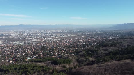 Cinematic-4k-drone-clip-flying-over-Vitosha-mountain-and-towards-the-prosperous-suburbs-of-Sofia,-Bulgaria