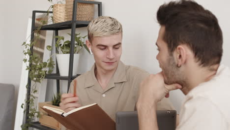 two men sitting at table indoors and having talk