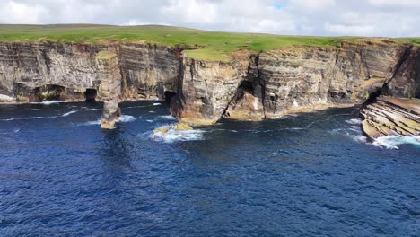 Scotland-UK,-Aerial-View-of-Rock-Stack-and-Scenic-Cliffs-Above-Sea-on-Sunny-Day