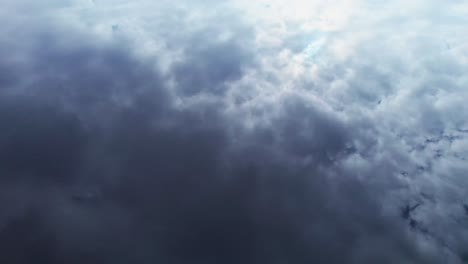 Clouds-from-heaven-reflecting-in-water-of-lake-from-drone-aerial,-natural-mirror