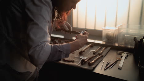 archaeologist examining ancient bones in a laboratory