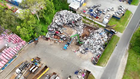 scrapyard operations with machinery and metal piles