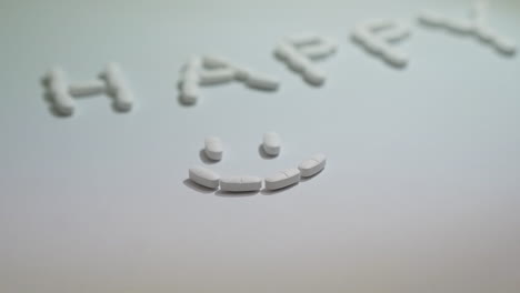 pills forming smiley face on white background