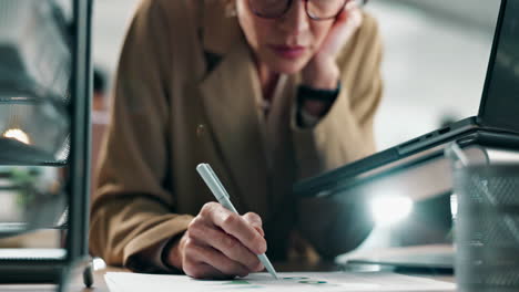 businesswoman analyzing graphs and reports in the office