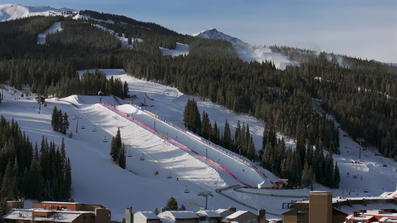 Copper Mountain Resort center village aerial drone chairlifts gondola Ikon Pass Alterra snowboarding snow ski riding trails morning winter solstice December halfpipe snow guns trees circle right