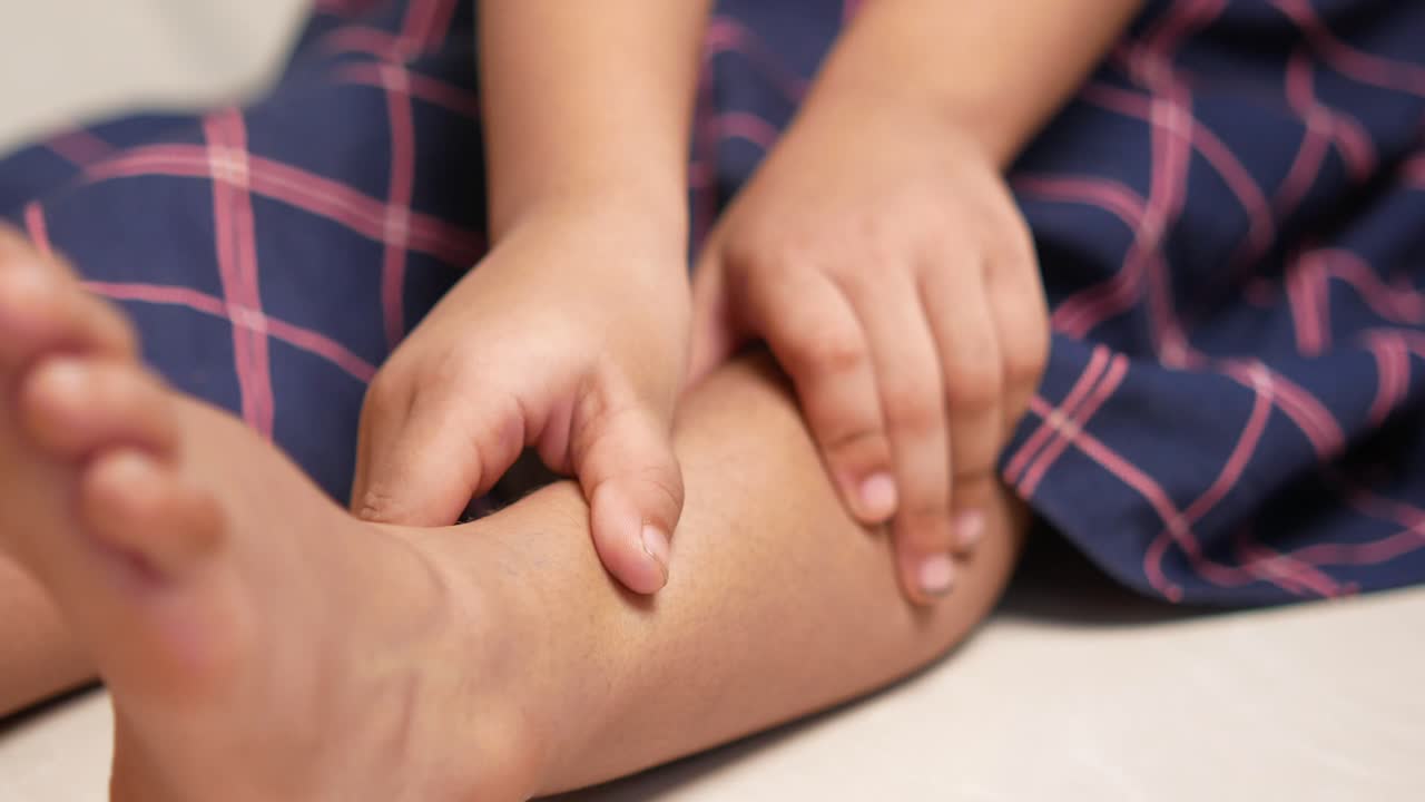 아이가 다리를 만지고 있습니다.