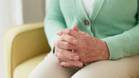 hands, anxiety and senior woman on a sofa