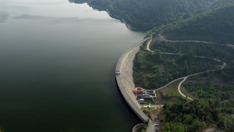 Aerial-view-of-Ordunte-lake-revervoir-dam,-concrete-construction,-Tilt-down-shot,-Spain