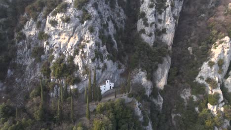 drone shot showcasing eremo di san valentino and cima comer, two popular destinations for hikers on lake garda