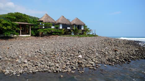 full is tilting up shot, scenic view of beach front huts on the bitcoin beach in el salvador mexico, on a bright sunny day