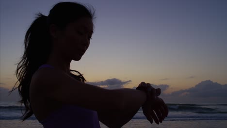 healthy chinese girl in sportswear jogging on beach
