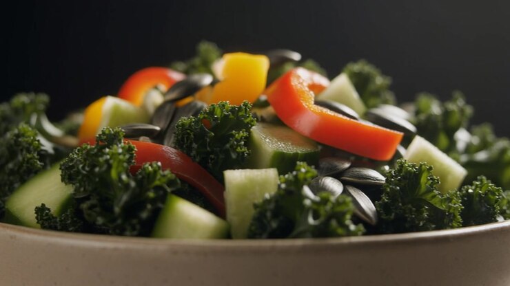 Fresh Vegetable Salad with Kale and Pumpkin Seeds in a Bowl