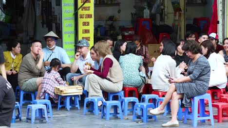 people sitting and interacting in hanoi, vietnam