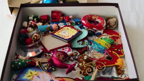 a box full of a variety of colorful christmas tree ornaments