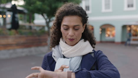 slow motion portrait of beautiful mixed race woman smiling using smart watch checking messages browsing enjoying city lifestyle