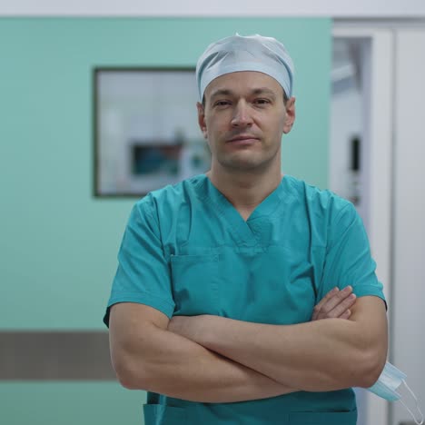 portrait of the professional surgeon looking into camera after successful operation. in the background modern hospital operating room