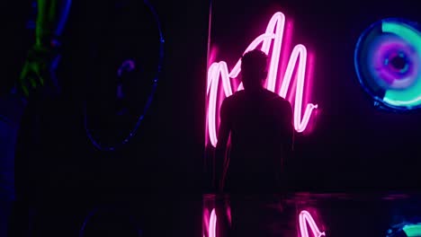 silhouette in a neon-lit space