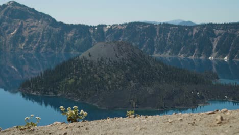 Volcano-island-in-the-middle-of-lake-surrounded-by-mountains