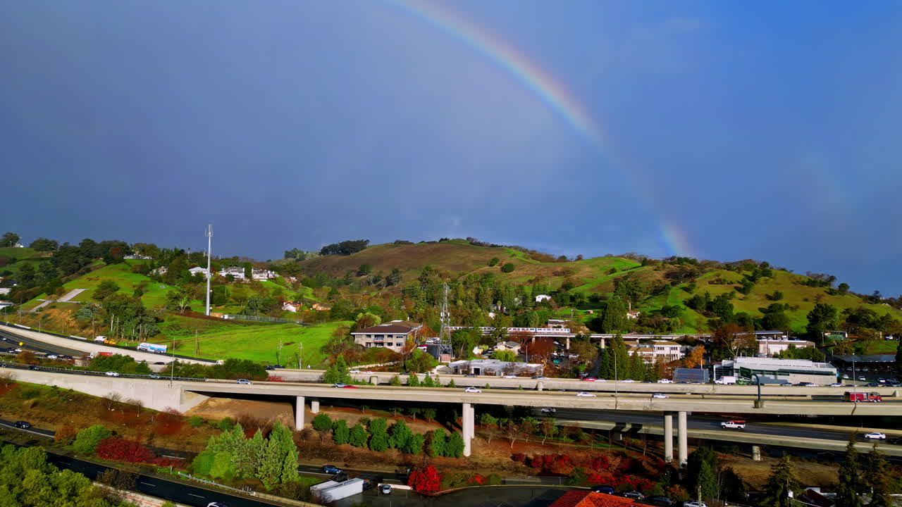 Vibrant rainbow arches over Walnut Creek, adding color to serene landscape