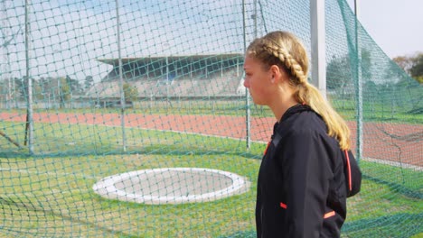 side view of caucasian female athlete walking on the sports field 4k